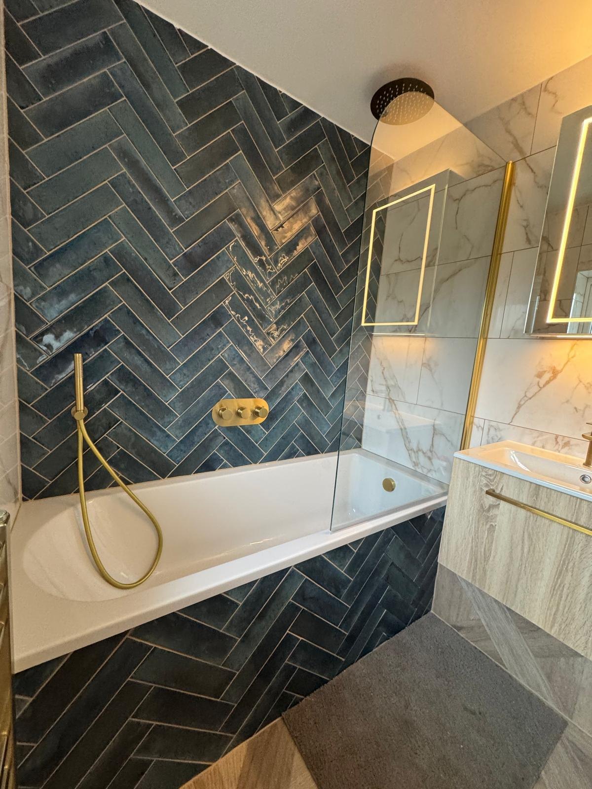 A teal-tiled en-suite with a backlit mirror