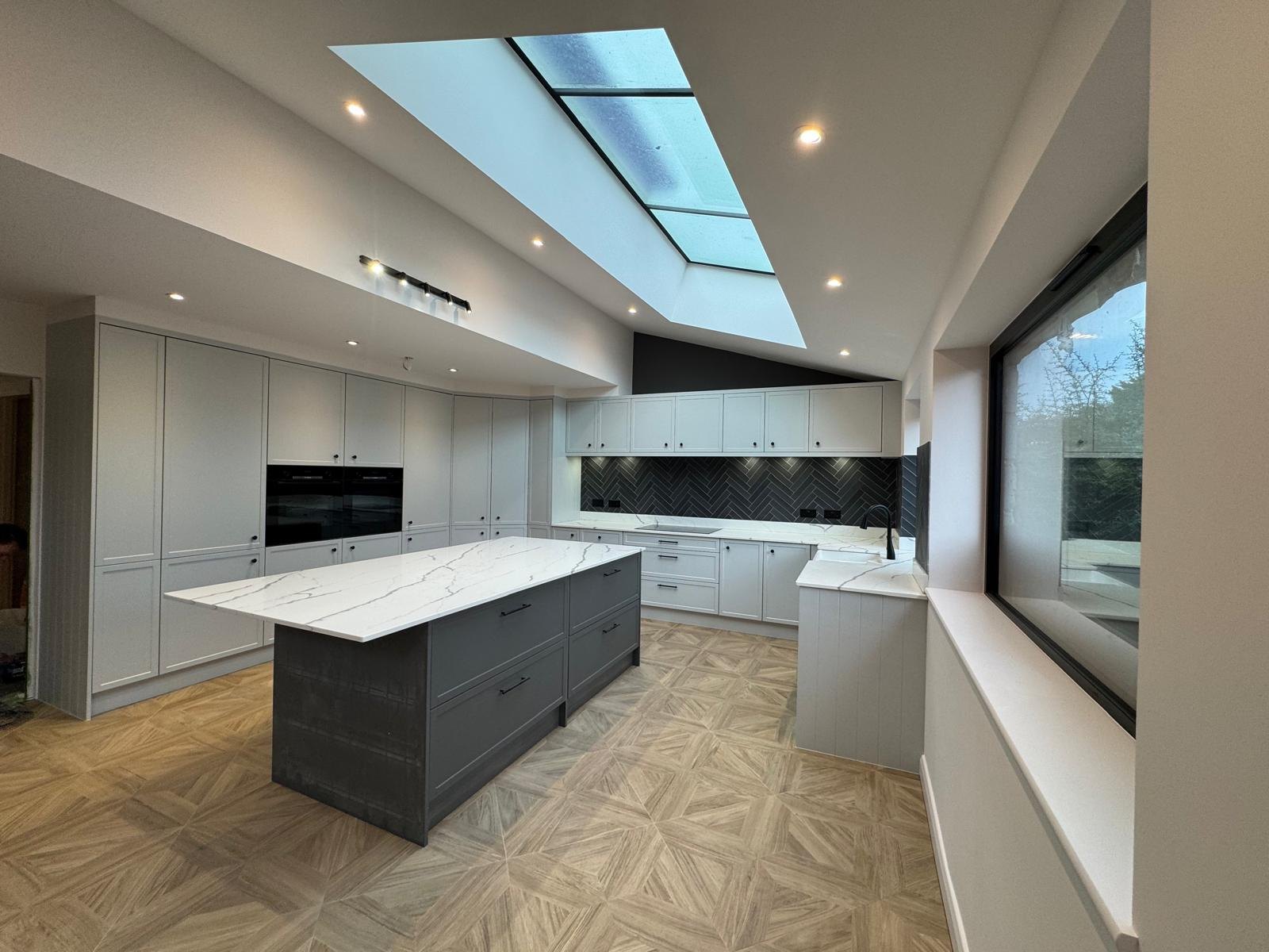 A bright open-plan kitchen extension with island and bi-fold doors