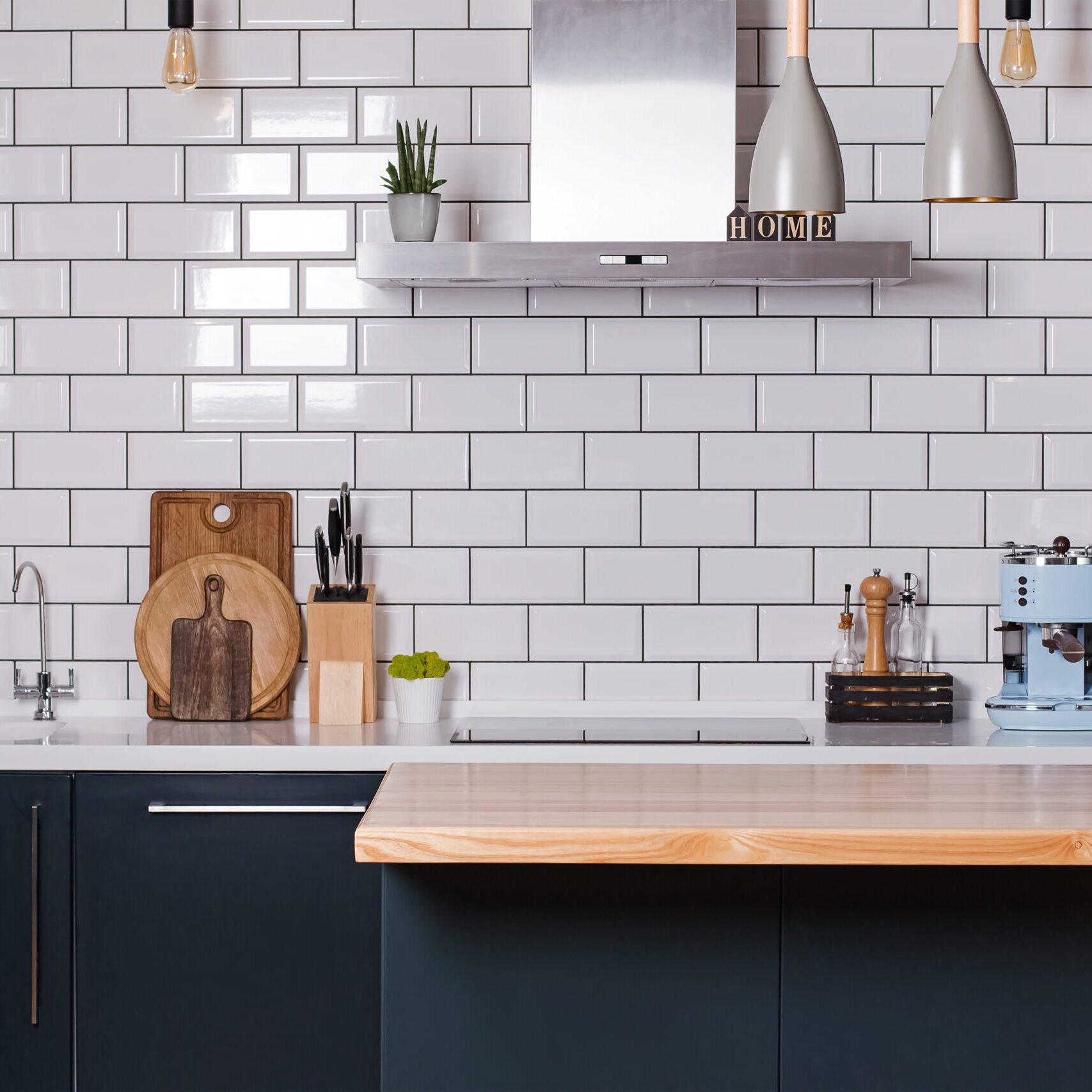 Modern interior design. Photo of kitchen with white tiles and dark furniture